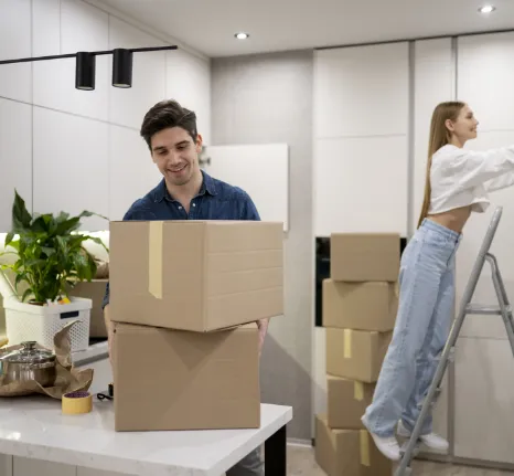 Mover handing a box to a woman